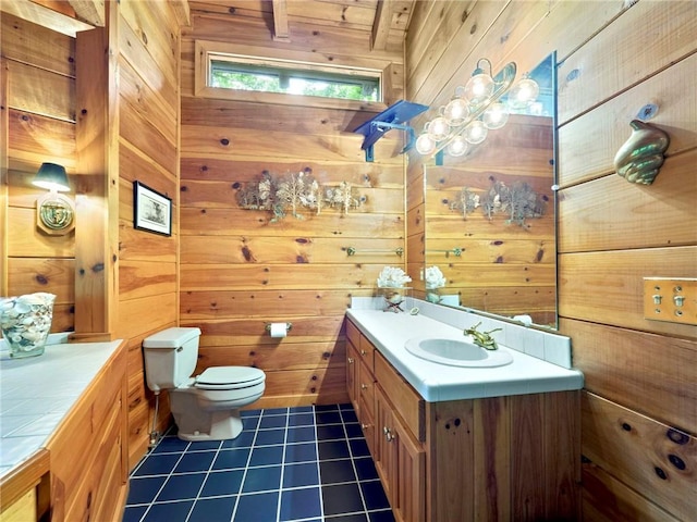 bathroom with toilet, wood ceiling, vanity, wooden walls, and tile floors