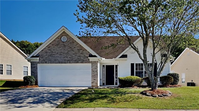 145 Charleston Pl, Covington, GA 30016 - single story home featuring central AC, concrete driveway, a front lawn, a garage, and brick siding