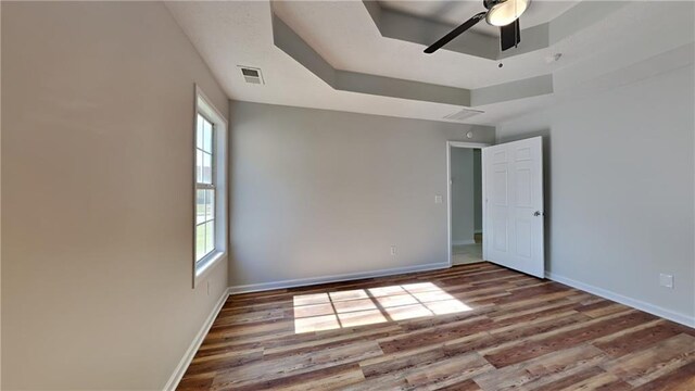 145 Charleston Pl, Covington, GA 30016 - spare room featuring ceiling fan, wood finished floors, visible vents, and plenty of natural light