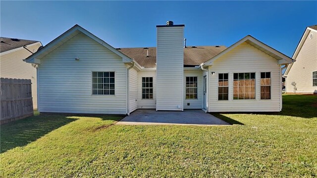 145 Charleston Pl, Covington, GA 30016 - back of house with a chimney, fence, a yard, and a patio