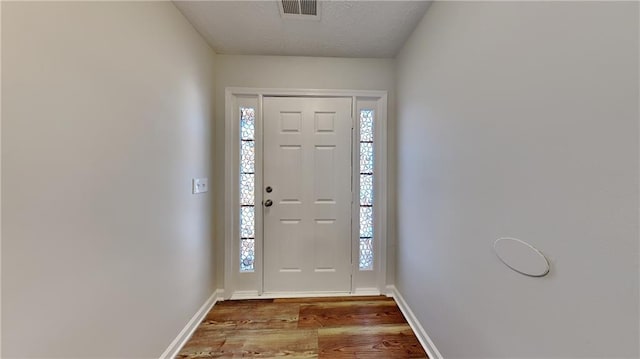 145 Charleston Pl, Covington, GA 30016 - entryway featuring baseboards, wood finished floors, visible vents, and a wealth of natural light