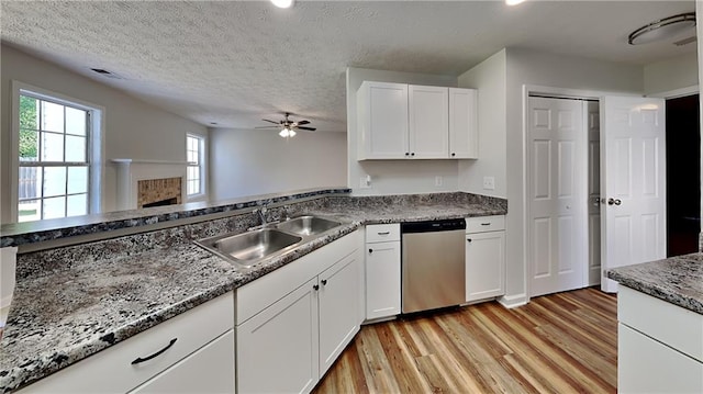 145 Charleston Pl, Covington, GA 30016 - kitchen with white cabinets, dishwasher, a sink, and light wood-style floors