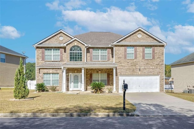 view of front of home featuring a front yard and a garage