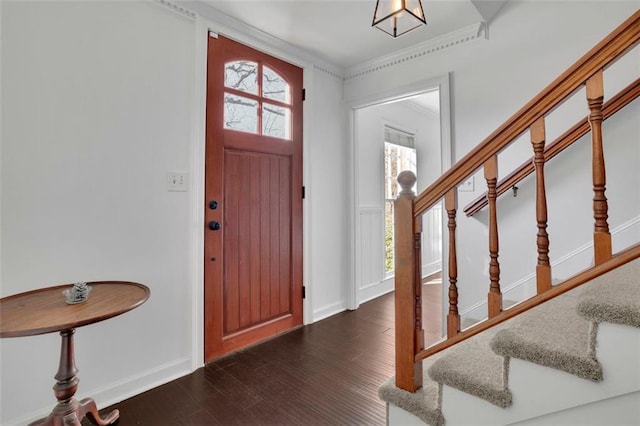 foyer entrance featuring dark hardwood / wood-style flooring and ornamental molding