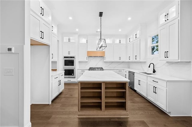 kitchen featuring a center island, tasteful backsplash, open shelves, a sink, and stainless steel appliances
