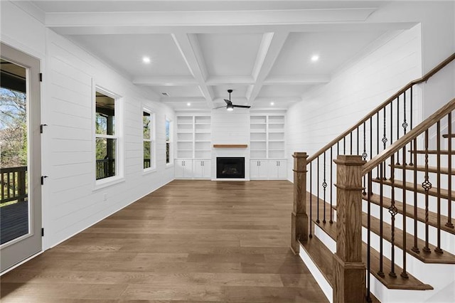 unfurnished living room with ceiling fan, a fireplace, recessed lighting, wood finished floors, and stairway