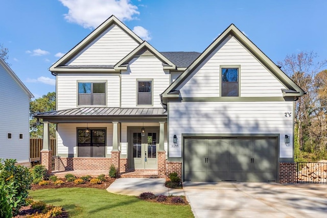 craftsman house featuring a porch, a standing seam roof, driveway, a garage, and brick siding