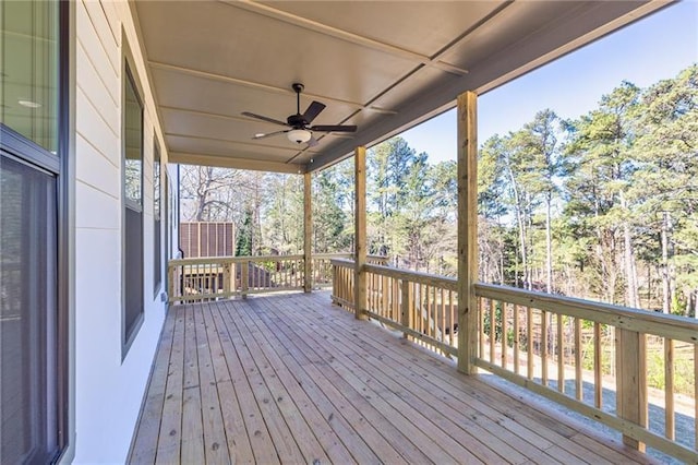 wooden terrace featuring a ceiling fan