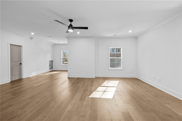 spare room featuring baseboards, ceiling fan, and wood finished floors