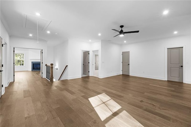 unfurnished living room with wood finished floors, baseboards, attic access, ceiling fan, and recessed lighting