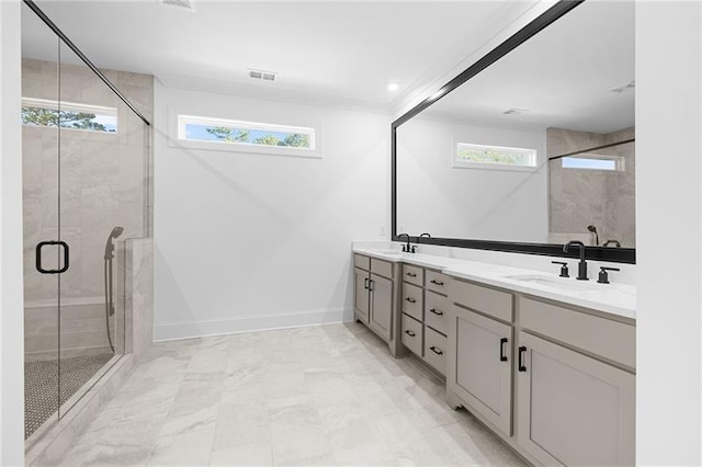 full bath featuring a sink, baseboards, a stall shower, and double vanity