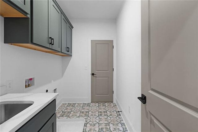 laundry area with washer hookup, electric dryer hookup, cabinet space, baseboards, and light floors