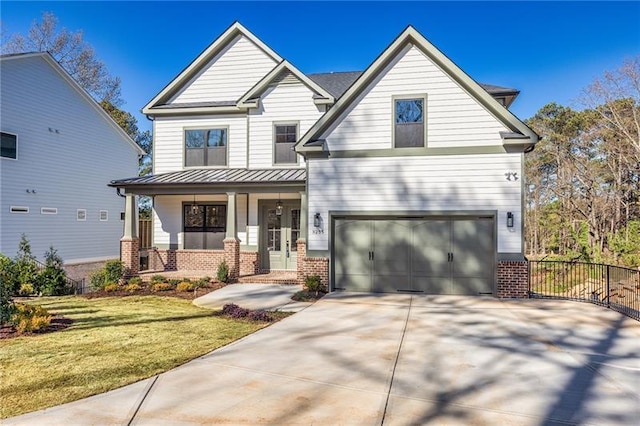 craftsman-style house featuring covered porch, driveway, a garage, brick siding, and a front lawn