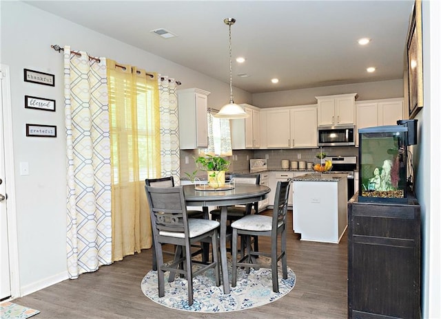 735 Sweethaven Ln, Loganville, GA 30052 - dining area featuring dark wood-type flooring and recessed lighting
