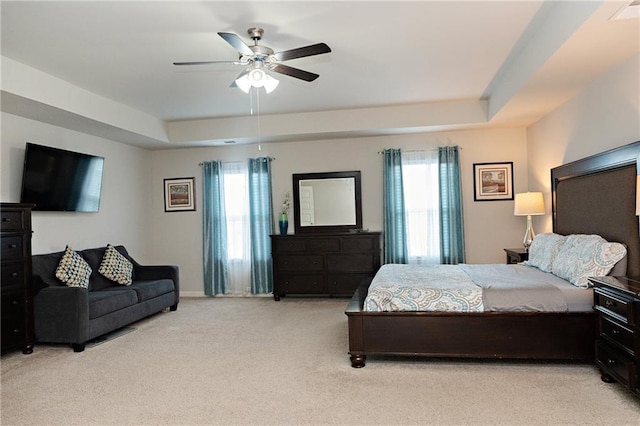 735 Sweethaven Ln, Loganville, GA 30052 - bedroom featuring multiple windows, light carpet, a raised ceiling, and ceiling fan