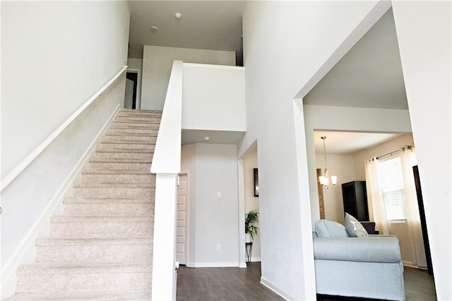 735 Sweethaven Ln, Loganville, GA 30052 - stairs with a chandelier and wood finished floors