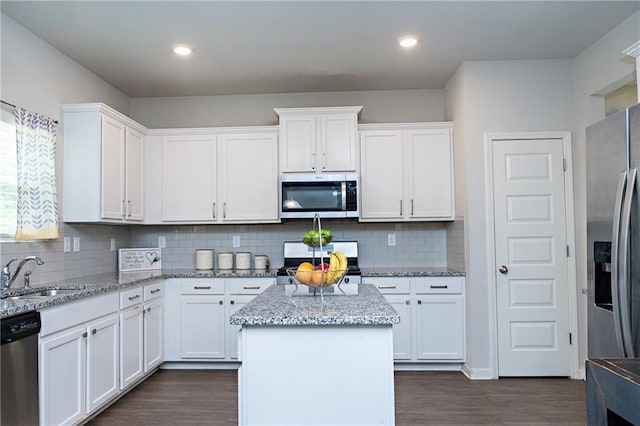 735 Sweethaven Ln, Loganville, GA 30052 - kitchen with stainless steel appliances, a sink, white cabinets, dark wood-style floors, and recessed lighting