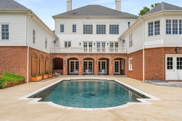 833 Hines Rd, Moreland, GA 30259 - back of property with a chimney, brick siding, an outdoor pool, a patio area, and french doors