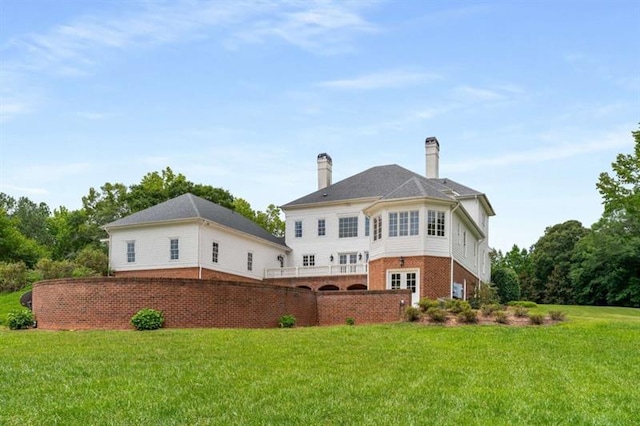 833 Hines Rd, Moreland, GA 30259 - back of property with a lawn, brick siding, and a chimney