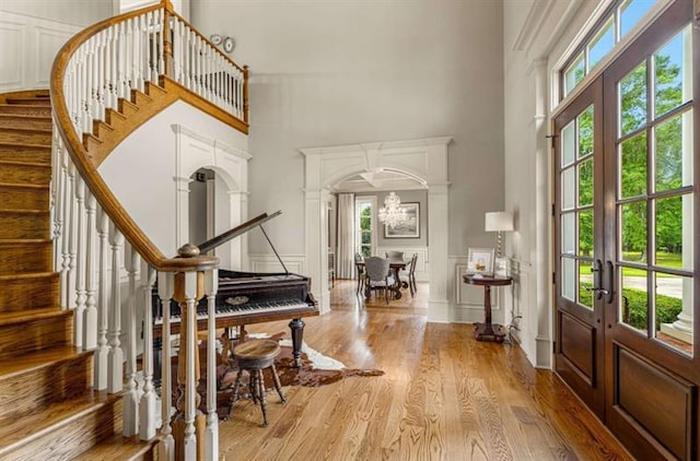 833 Hines Rd, Moreland, GA 30259 - entryway featuring a towering ceiling, french doors, stairs, wood finished floors, and a decorative wall