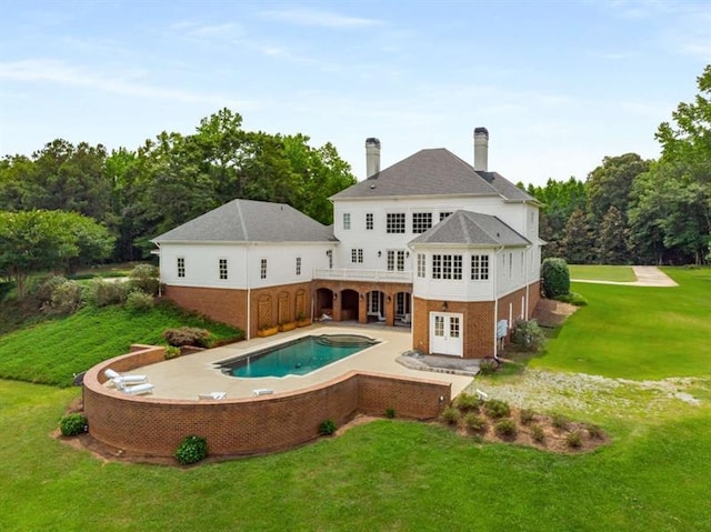 833 Hines Rd, Moreland, GA 30259 - rear view of property featuring brick siding, a yard, a patio area, an outdoor pool, and a chimney