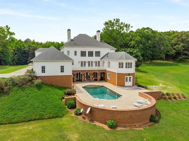 833 Hines Rd, Moreland, GA 30259 - rear view of property featuring brick siding, a lawn, an in-ground hot tub, a patio, and an outdoor pool
