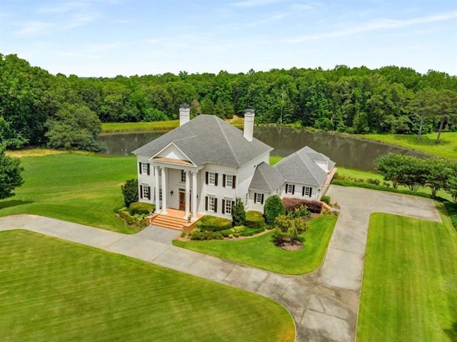 833 Hines Rd, Moreland, GA 30259 - neoclassical home with a chimney, curved driveway, a water view, a front lawn, and a wooded view