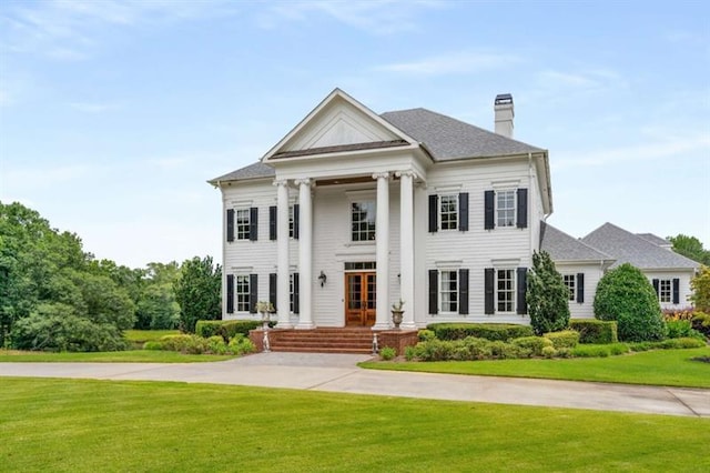 833 Hines Rd, Moreland, GA 30259 - neoclassical home with a front lawn, french doors, and a chimney