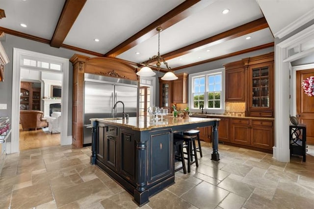 833 Hines Rd, Moreland, GA 30259 - kitchen with stone tile flooring, stainless steel built in fridge, beam ceiling, brown cabinets, and ornamental molding