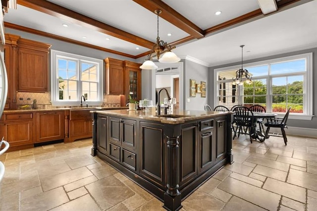 833 Hines Rd, Moreland, GA 30259 - kitchen with stone tile flooring, healthy amount of natural light, brown cabinetry, ornamental molding, and beam ceiling