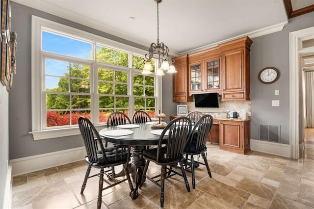 833 Hines Rd, Moreland, GA 30259 - dining space with ornamental molding, stone tile floors, and a chandelier