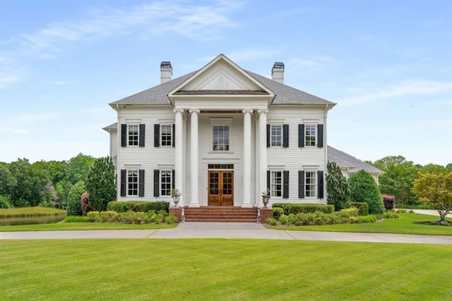 833 Hines Rd, Moreland, GA 30259 - neoclassical home featuring french doors, a front yard, and a chimney