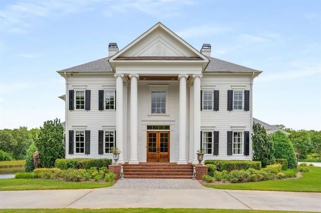 833 Hines Rd, Moreland, GA 30259 - greek revival inspired property with french doors, a chimney, and a front lawn