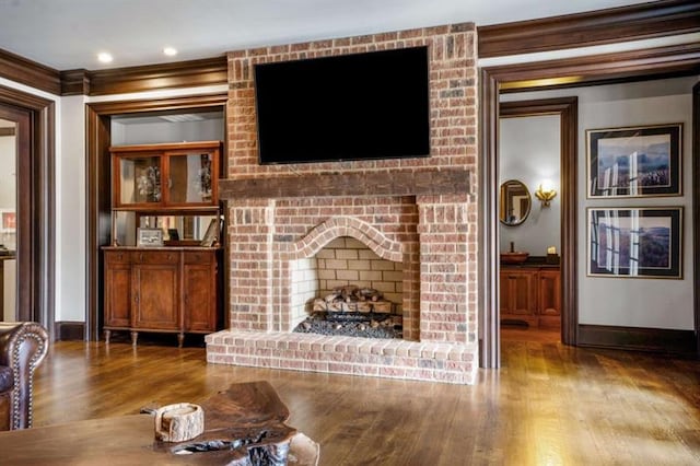 833 Hines Rd, Moreland, GA 30259 - living room with wood finished floors, crown molding, and a fireplace