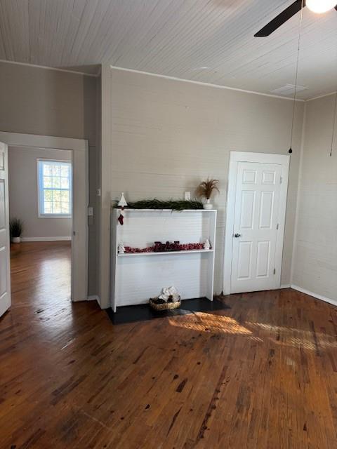 interior space featuring ceiling fan and dark wood-type flooring