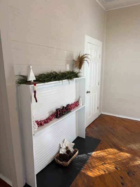 mudroom featuring dark hardwood / wood-style flooring and ornamental molding