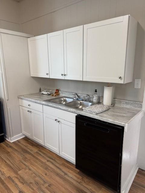 kitchen featuring black dishwasher, white cabinetry, dark wood-type flooring, and sink