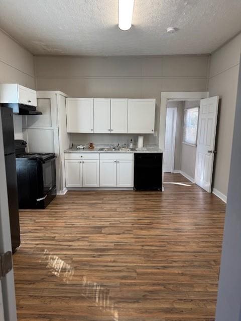 kitchen with white cabinets, a textured ceiling, dark hardwood / wood-style floors, and black appliances