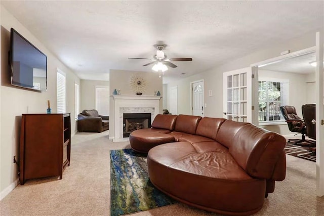 carpeted living room featuring ceiling fan