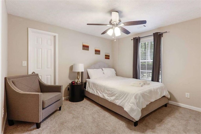 bedroom with light colored carpet and ceiling fan