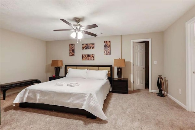 bedroom with ceiling fan and light colored carpet