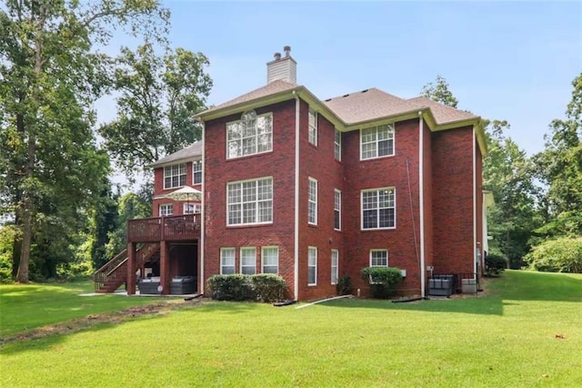 rear view of house featuring central AC unit, a deck, and a yard