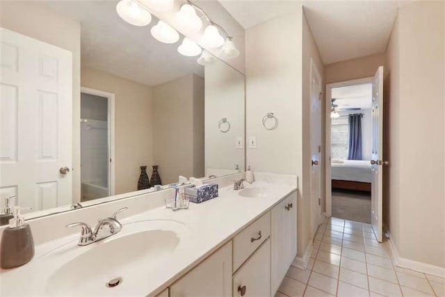 bathroom with tile patterned flooring, vanity, and ceiling fan