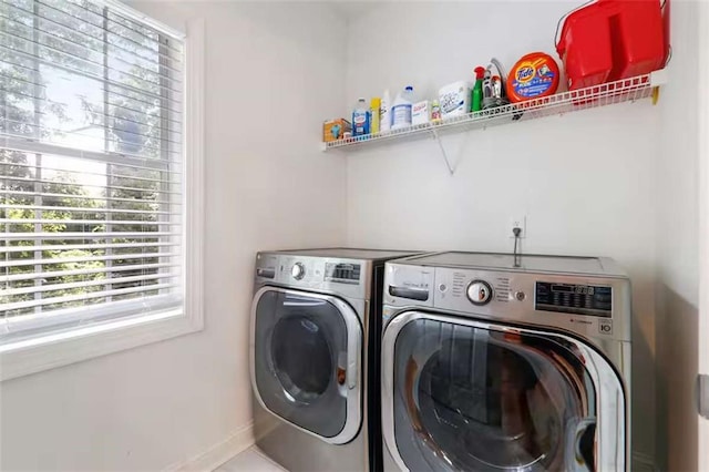 clothes washing area with washer and clothes dryer