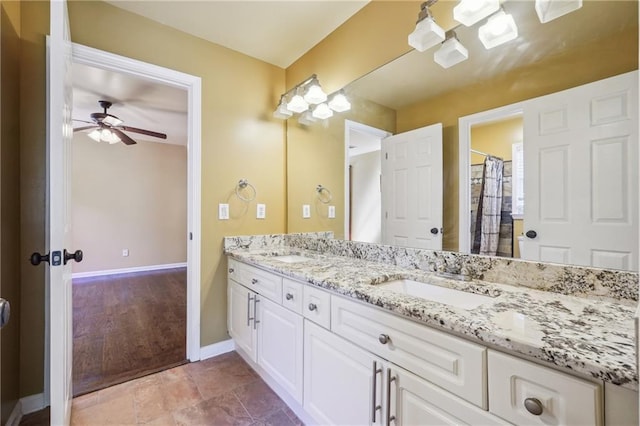 bathroom with ceiling fan, vanity, and curtained shower