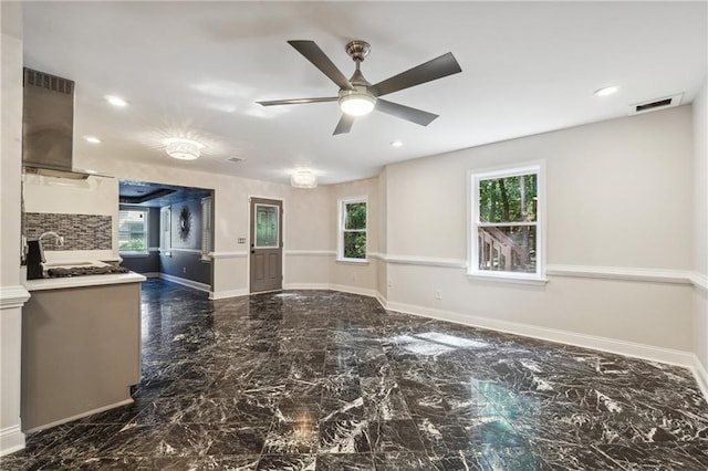 interior space featuring island range hood and ceiling fan