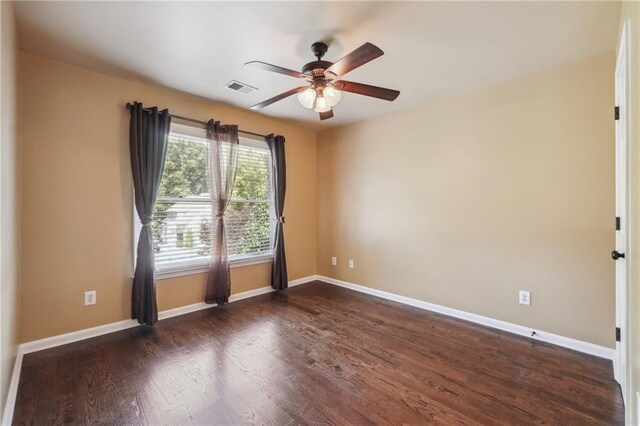 empty room with ceiling fan and dark hardwood / wood-style floors