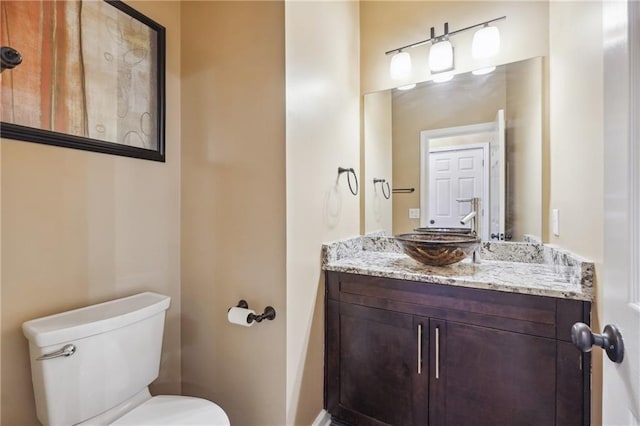 bathroom with toilet and vanity