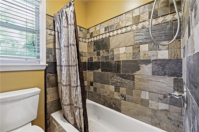 bathroom featuring toilet and shower / bathtub combination with curtain