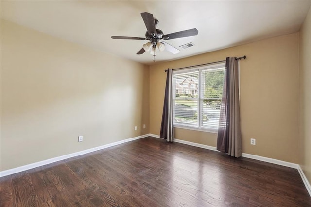 empty room featuring dark wood-type flooring and ceiling fan